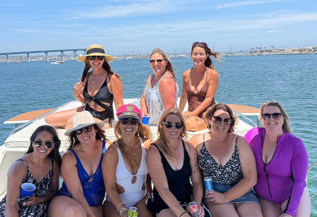 Friends enjoying a sunny San Diego Bay boat outing aboard a private yacht charter