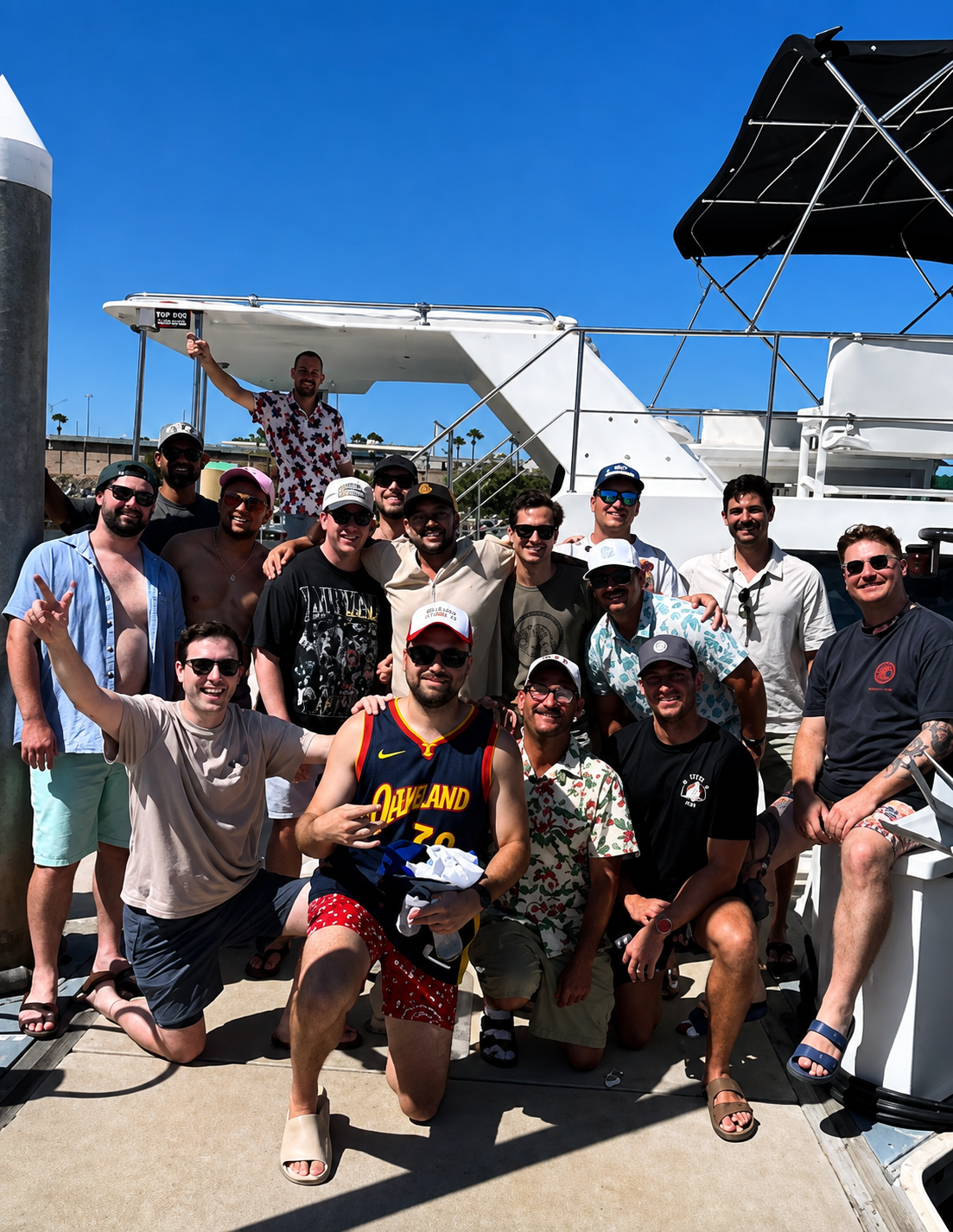 Group of friends posing together aboard a private yacht charter in San Diego