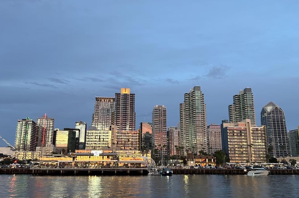 San Diego Bay skyline at dusk from private yacht charter — downtown waterfront viewed from the water