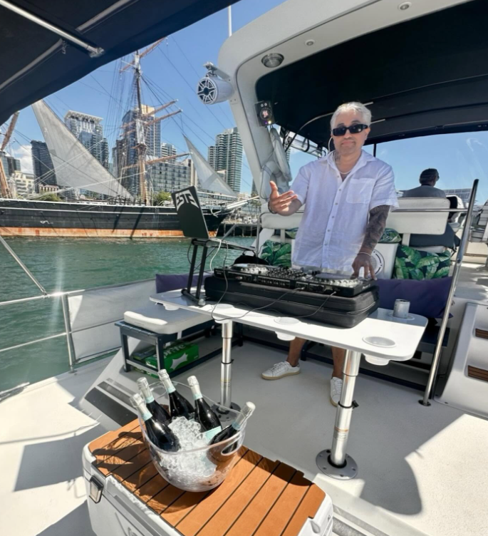 DJ performing on private yacht charter with Star of India and San Diego skyline backdrop