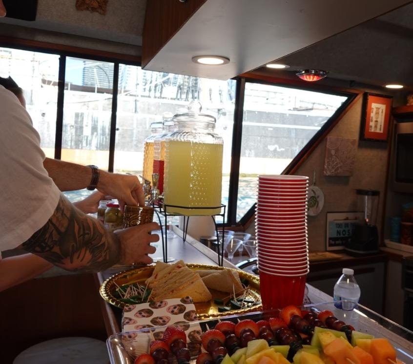 Catered food and beverages setup inside the Paradise Party Yacht cabin — private charter San Diego Bay