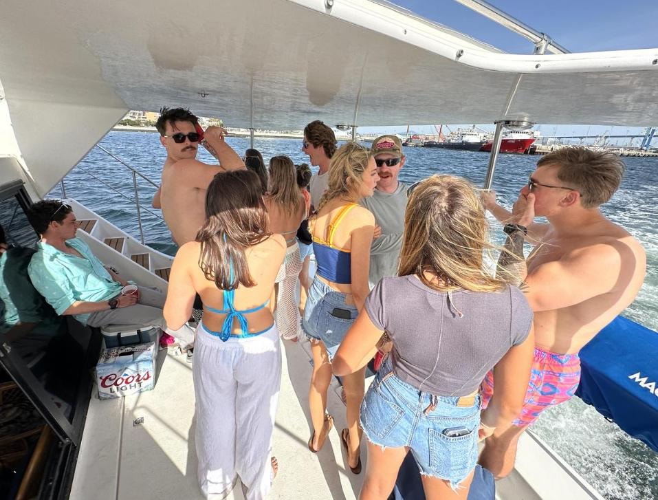 Group of friends on private yacht charter on San Diego Bay — casual boat party outing
