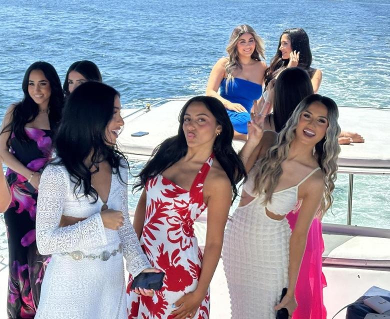 Group of women in elegant dresses celebrating on private yacht charter on San Diego Bay — party boat rental