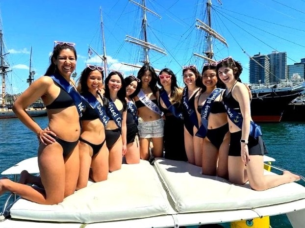 Private party boat San Diego — group on upper deck of yacht charter celebrating on the bay