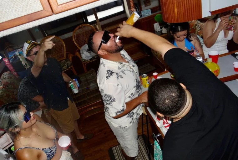 Private party boat San Diego — guests celebrating inside yacht charter cabin on San Diego Bay