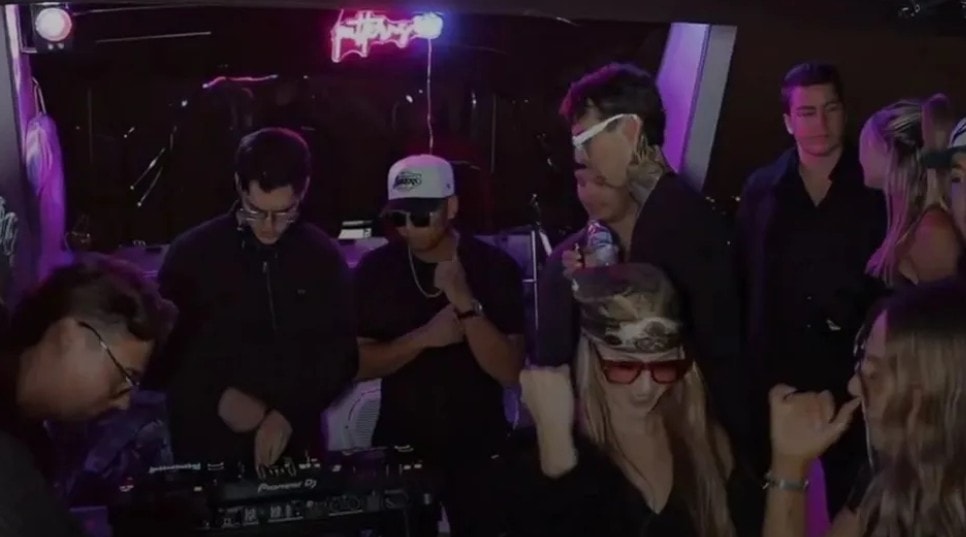 San Diego yacht charter — DJ and guests partying under neon lights inside private party boat cabin