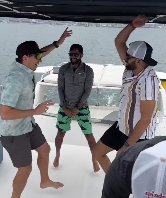 Bachelor party boat San Diego — guys dancing and celebrating on private yacht deck on the bay