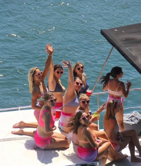 San Diego bachelorette party boat — women celebrating on private yacht bow during bay cruise