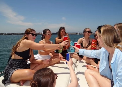 Private yacht charter San Diego — women toasting drinks on the bow of the Paradise Party Yacht on San Diego Bay