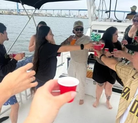 San Diego party boat — friends toasting red cups on private yacht charter on San Diego Bay