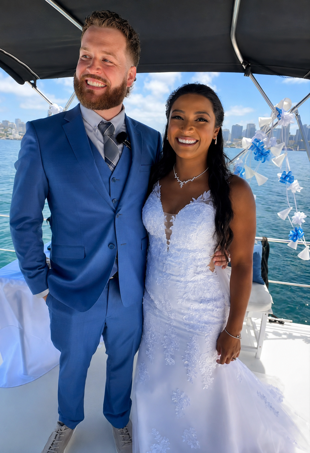 Wedding couple smiling on private yacht charter San Diego Bay — bride and groom boat wedding