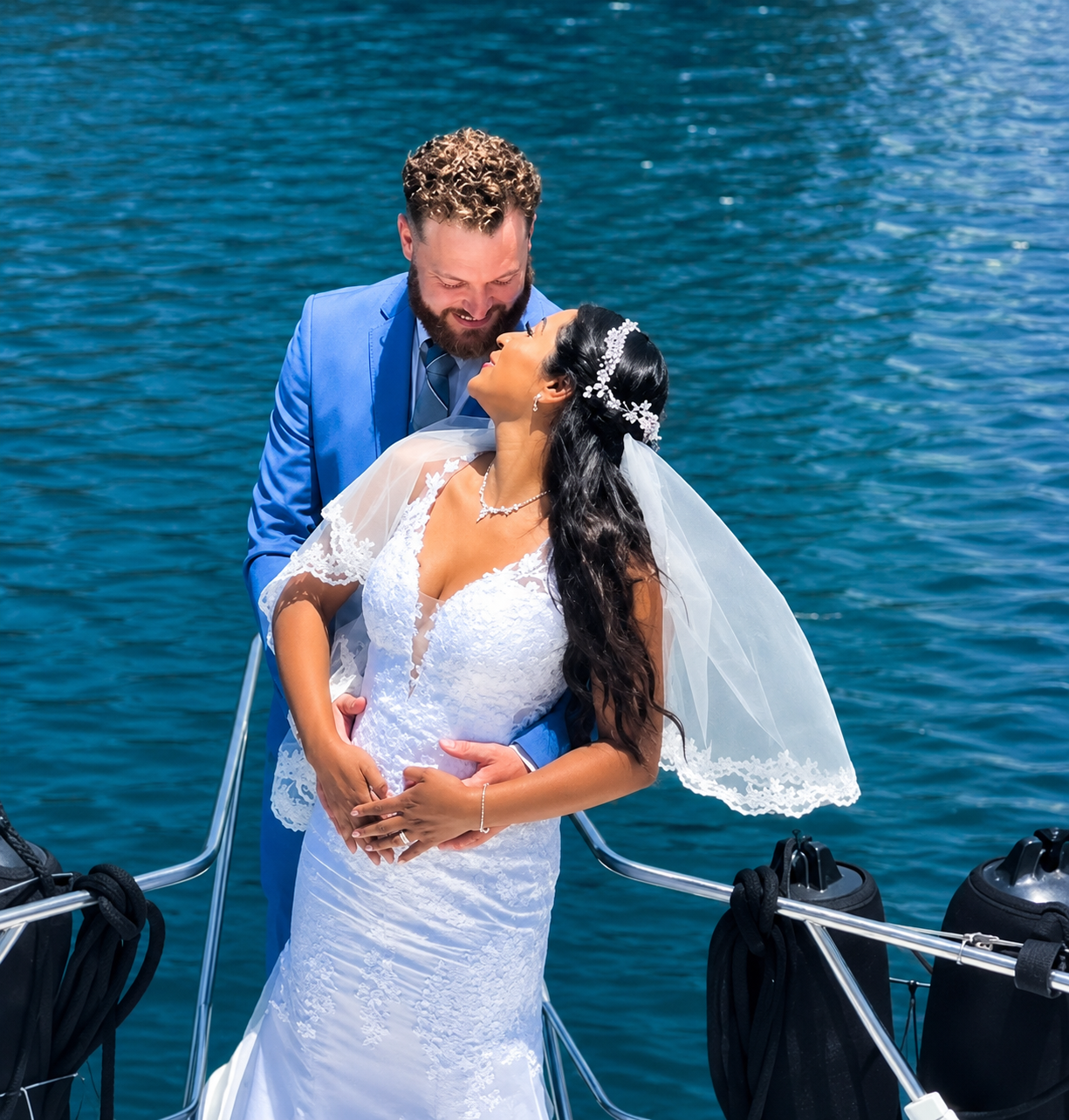 Romantic wedding couple embracing on private yacht charter San Diego Bay — boat wedding ceremony