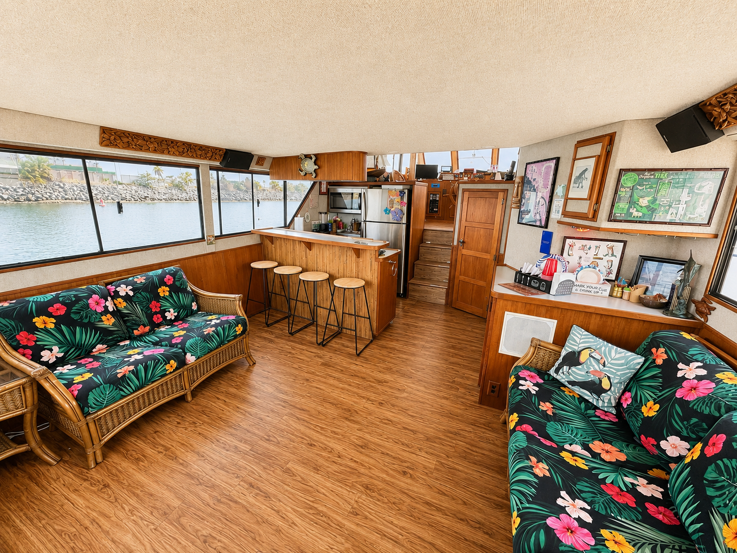 Yacht interior lounge San Diego — tropical rattan sofas and bar area aboard the Paradise Party Yacht
