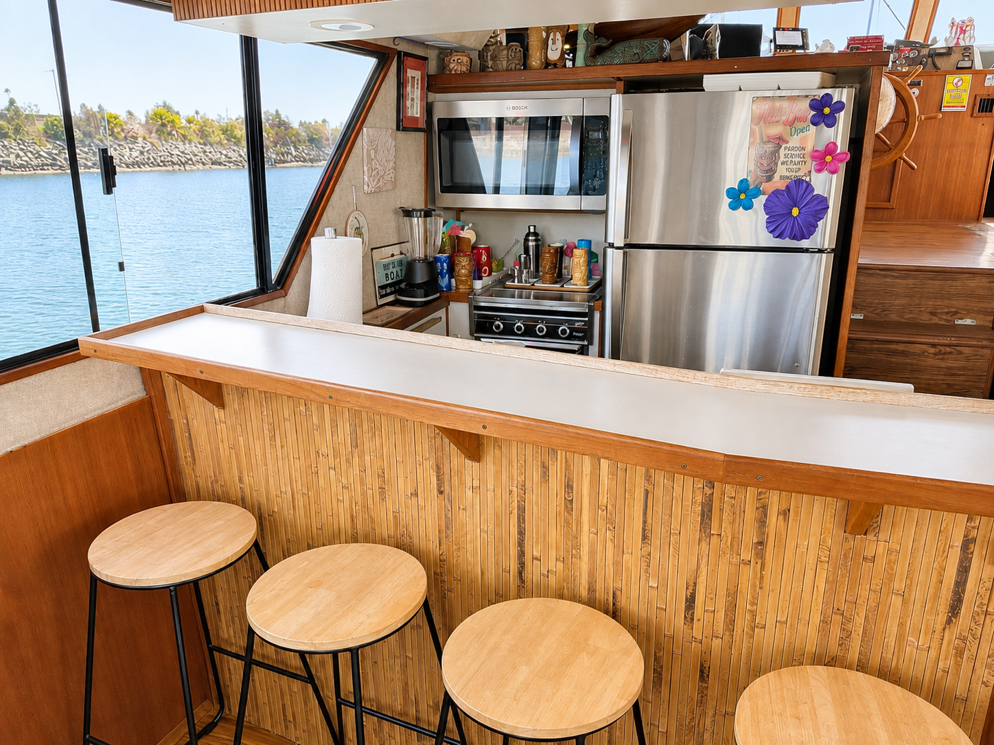 Yacht bar San Diego — full galley bar with stools and refrigerator aboard the Paradise party yacht